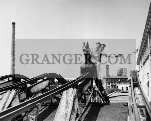 0171759-CONEY-ISLAND-RIDE-1943-A-young-couple-enjoying-the-horse-ride-at-Steeplechase-Park-at-Coney-Island-Brooklyn-New-York-25-June-1943-The-young-man-has-a-ride-ticket-tied-to-his-finger.jpg